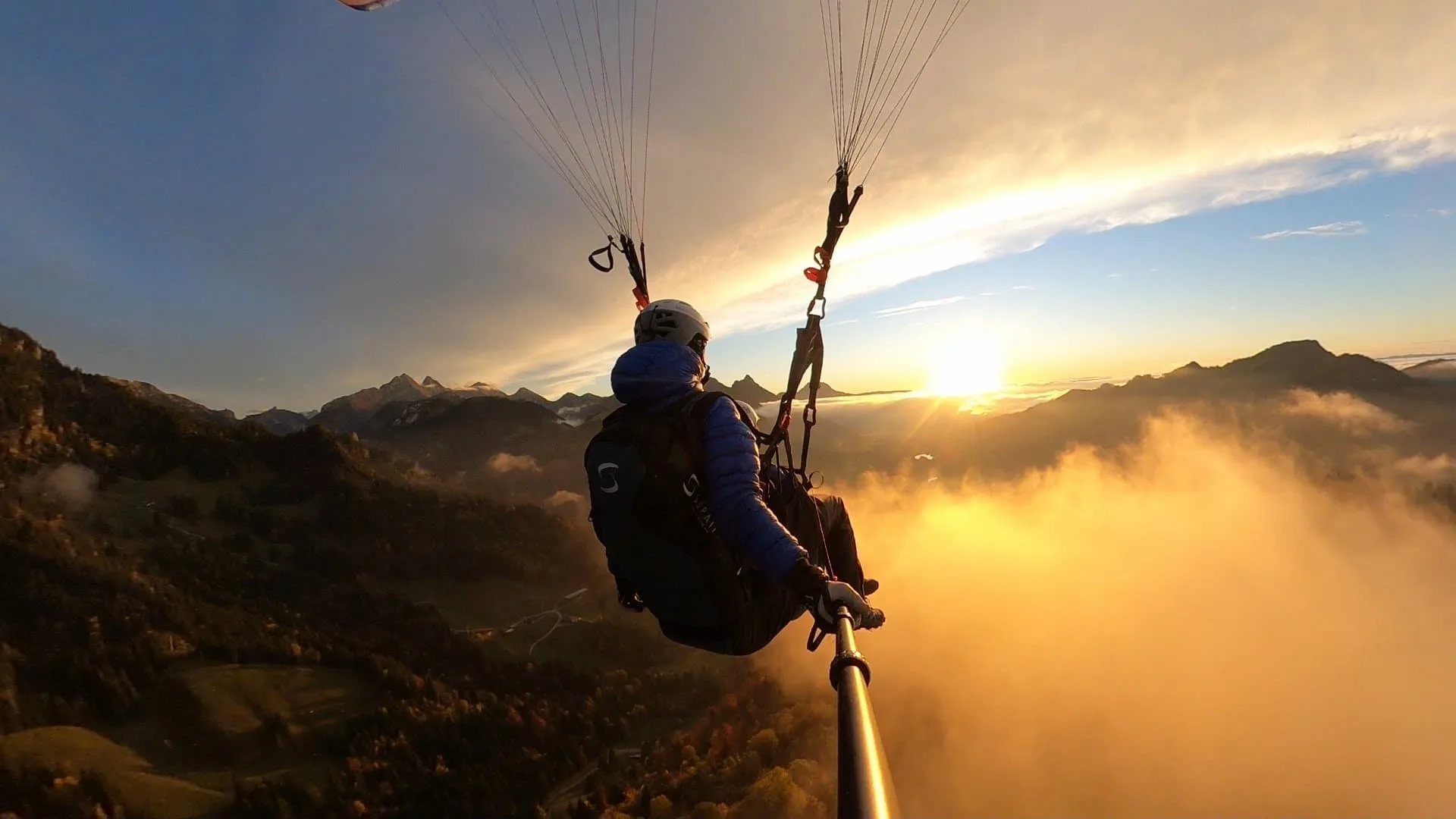 Tandem paraglider at sunset in the mountains of Valais.
